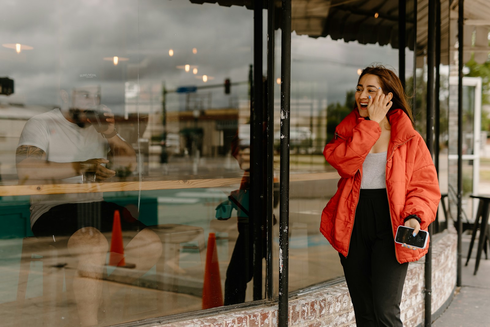 Business owner smiling while using her phone